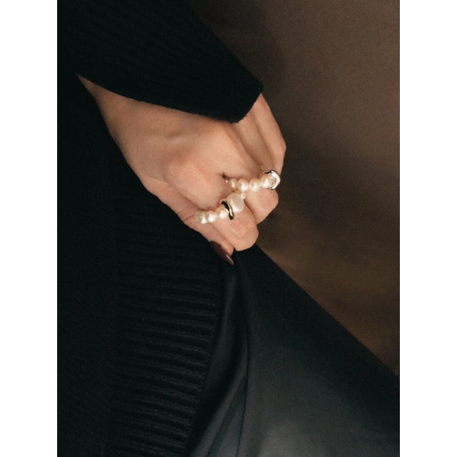 The Glimmer Ring is carefully hand-made with a combination of freshwater pearls, and a hand-carved divider, strung with a...