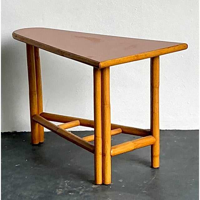 This unique "pie slice" side table is a masterful expression of 1950s tropical modernism, perfect for those seeking to...