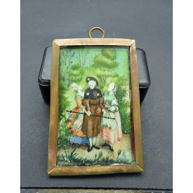 This elegant 18th century French miniature portrait painting showcases a charming scene of a gentleman accompanied by two...