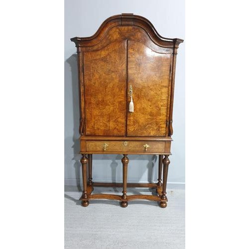 This is a very impressive walnut two door cabinet which encloses two drawer and two shelves sitting on five leg stand with...
