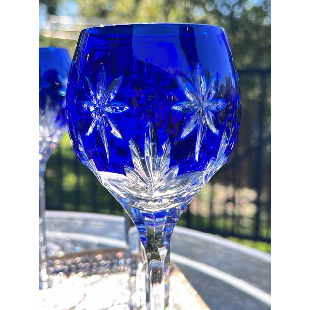 This is a gorgeous set of 9 cut-to-clear crystal wine glasses in a gorgeous sapphire blue and clear design. Made by Horst...