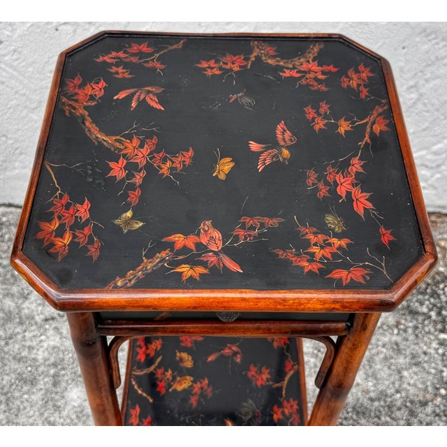 Chinoiserie Lacquered Bamboo 3-Tier Pedestal with Drawer Attributed to the workshop of Theodore Alexander This exquisite...