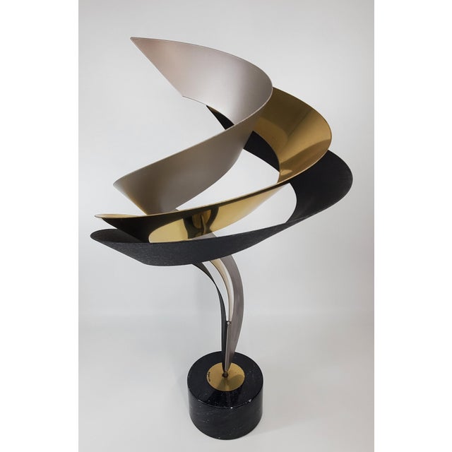 A nice tabletop sculpture by C. Jere. It looks different depending on what angle you set it up. A very sleek and elegant...
