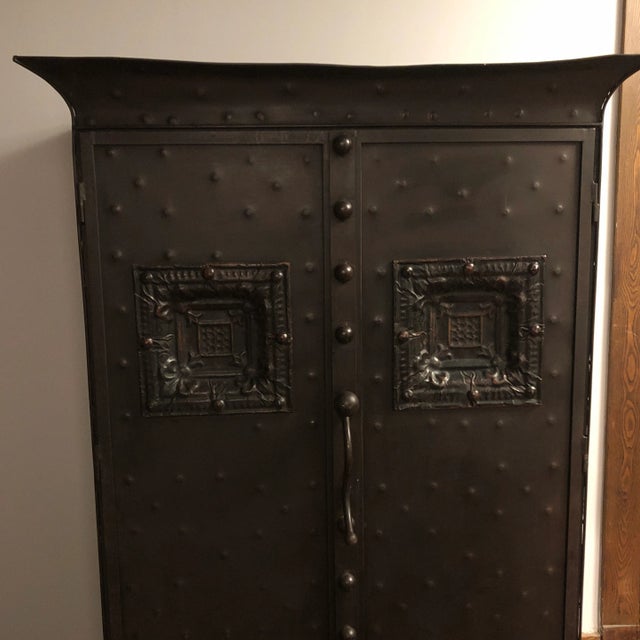 Unique metal sculpted storage cabinet ,lots of texture and storage. double doors cool curved handle tapered legs with ball...