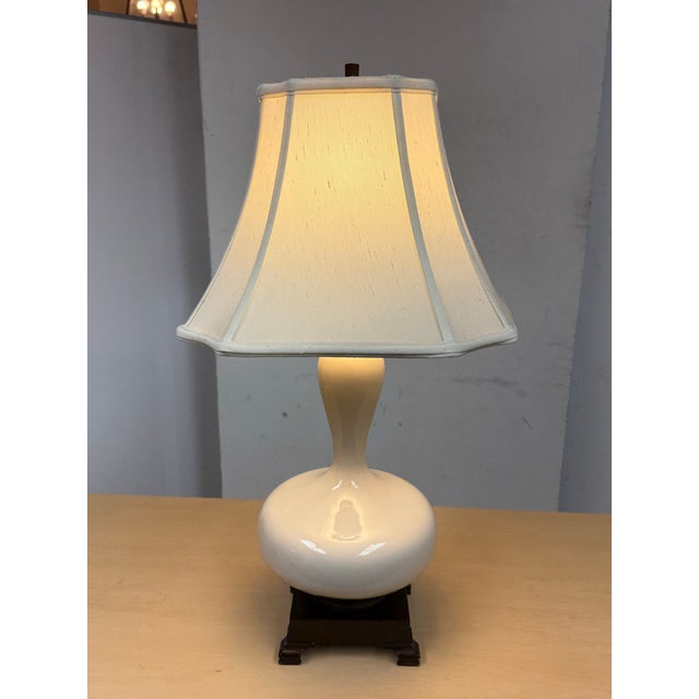 Design Plus Gallery presents an Aladdin Style Table Lamp. The lamp is an off white tone of porcelain in the shape of a...