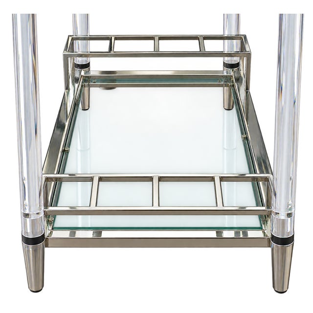 Striking vintage 1970s two-tier bar cart featuring a glamorous combination of clear acrylic, polished chrome and glass....