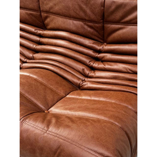 French Togo Three-Seater Sofa in Cognac Cow Leather by Michel Ducaroy for Ligne Roset, in Restored conditions. Designed...
