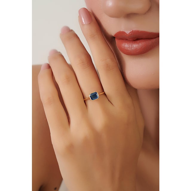 This solitaire ring features a 1.07 carat octagon cut blue sapphire set in 14K yellow gold. The sapphire measuring 5 x 6.5...