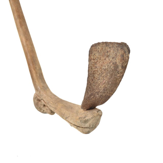This Lobi tool, crafted with precision and practicality, embodies the ingenuity of the Lobi people in West Africa....