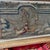 An early tapestry fragment of an angel with the sun above and a building beneath. The angel is a focal point in the center...
