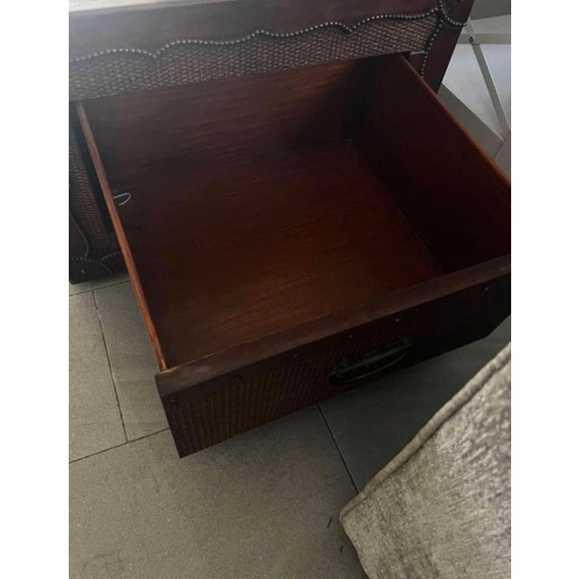 Elegant Ralph Lauren coffee table is constructed with woven rattan panels and a dark wood frame. This trunk-style piece...
