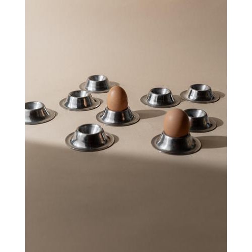 This vintage set of 9 stainless steel egg cups from the 1970s features a timeless, minimal design focused on clean lines...