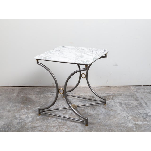 A French steel and bronze console table from the mid 20th century, with marble top and rosette medallion. Created in...