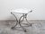 A French steel and bronze console table from the mid 20th century, with marble top and rosette medallion. Created in...