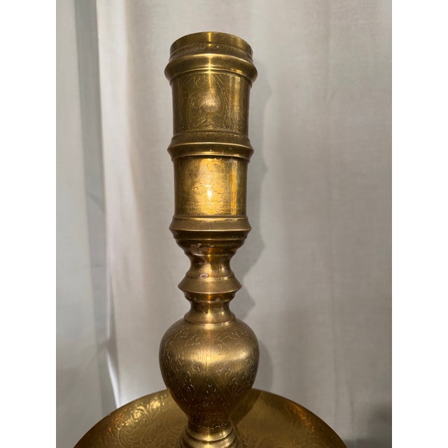 Elevate your space with this spectacular pair of monumental 49.5-inch vintage Moroccan solid brass floor candlesticks....