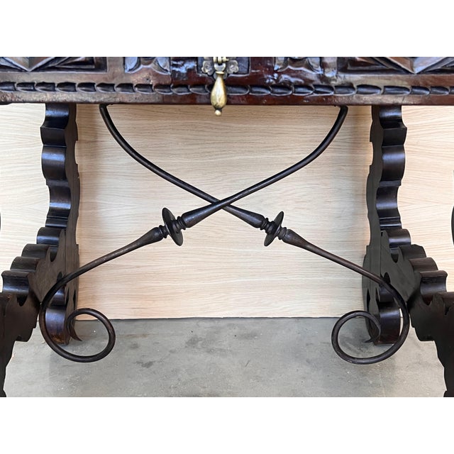 This Spanish 19th century features a beautiful one plank rectangular top over a carved drawer featuring slightly different...