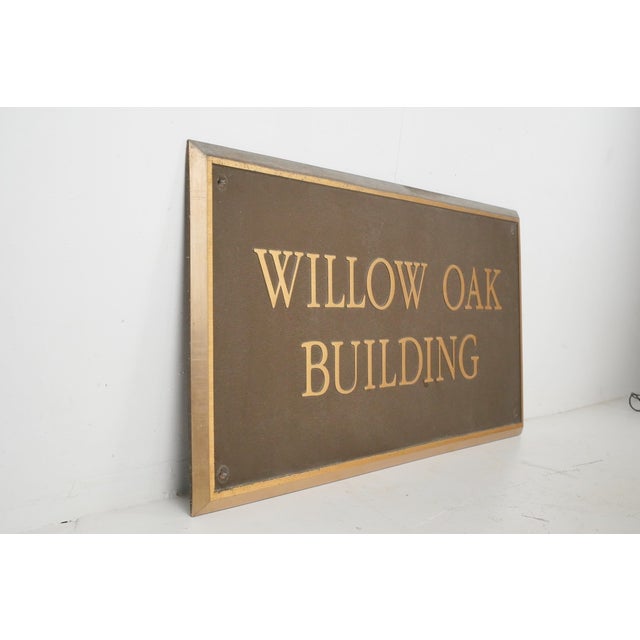 This specific sign is made of solid cast bronze with a pebbled brown background texture. It features raised, brushed satin...