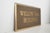 This specific sign is made of solid cast bronze with a pebbled brown background texture. It features raised, brushed satin...
