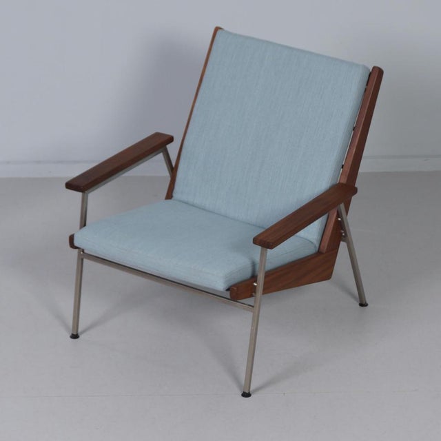 Gelderland armchair 2520 from the 1960s with an open metal frame, blue upholstery and a slightly reclined seat. The...