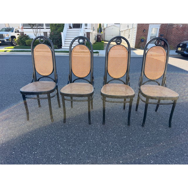 Set of 4 Thonet style dining chairs with cane seating and back rest. Dimensions: H: 43.5” W: 17” D: 17” SH: 18.5” SW: 16”...