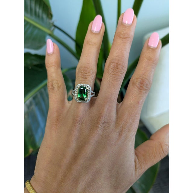 A chrome tourmaline blazes in vivid, saturated green at the center of this solid two-tone 14K white and yellow gold ring,...