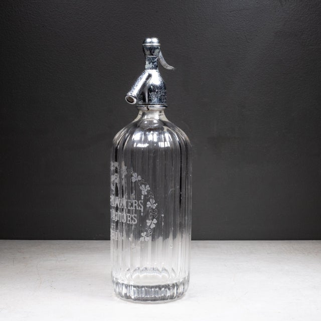 ABOUT Art deco ribbed heavy glass mineral water seltzer siphon bottle with chrome plated dispensing head. Etched "Mineral...