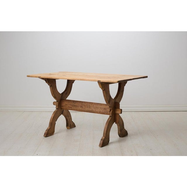 Primitive antique trestle table from northern Sweden made by hand around 1820 in solid pine. The pine has never been...