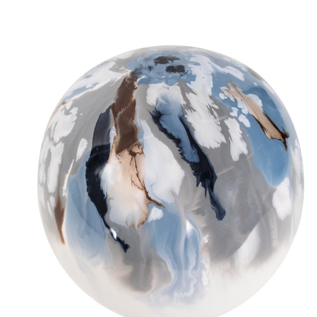 Featuring a captivating mix of swirling blues, whites, and metallic tones. Its polished surface reflects light elegantly,...