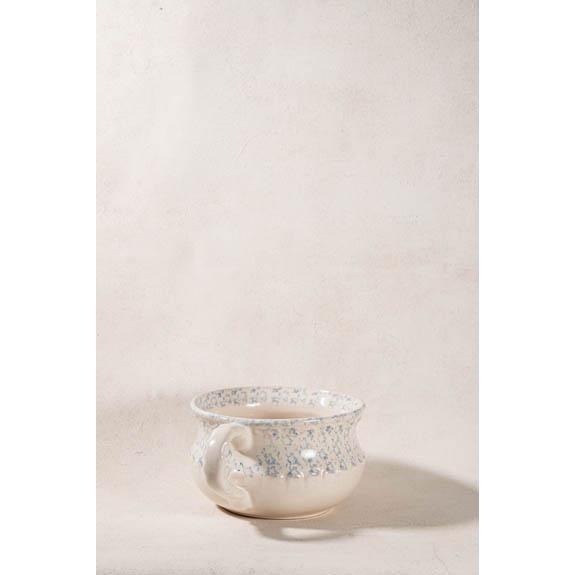 American spongeware mixing bowl with a single handle, cream ground, and pale blue hand-sponged decoration. Thick stoneware...