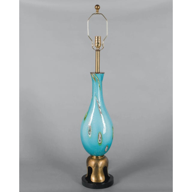 A Mid Century Murano art glass table lamp by Barovier & Toso. Hand blown aqua blue glass with colorful murrines and silver...