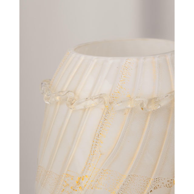 White Murano glass vase with touches of gold dust, made by Stefano Toso. Globular body with striated decoration and...