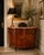 Elegant Italian neoclassical-style demilune cabinet featuring richly figured walnut veneers with intricate marquetry and...