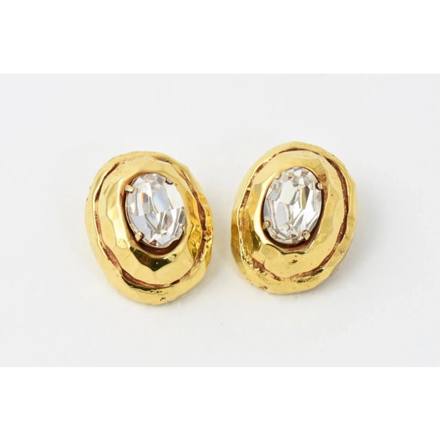 Kalinger Paris hammered goldtone earrings with large oval Swarovski crystal centers, circa 1985. Signed Kalinger Paris....