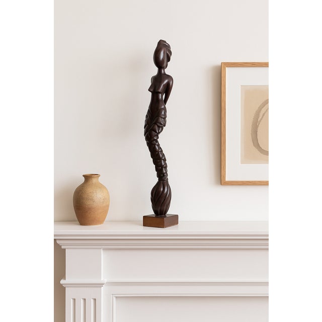 Decorative carved hardwood figure, Southeast Asian, mid–late 20th century. A tall, skinny stylized female nude rendered in...