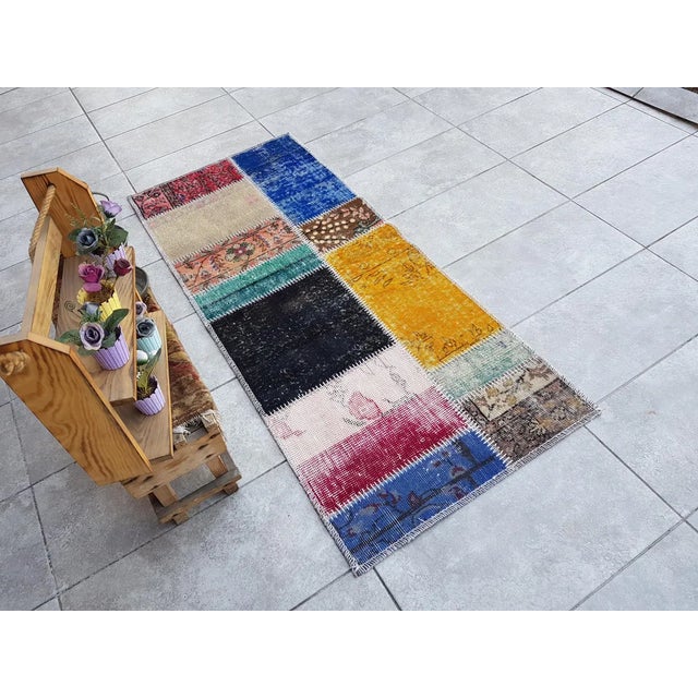 This is a vintage Turkish Oushak rug from the Mid 20th Century. The piece was hand-knotted.