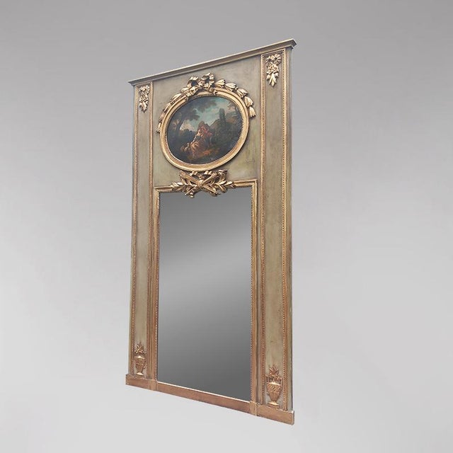 A Louis XVI style, patinated green wood Napoleon III period overmantel mirror. The upper section is adorned with a...