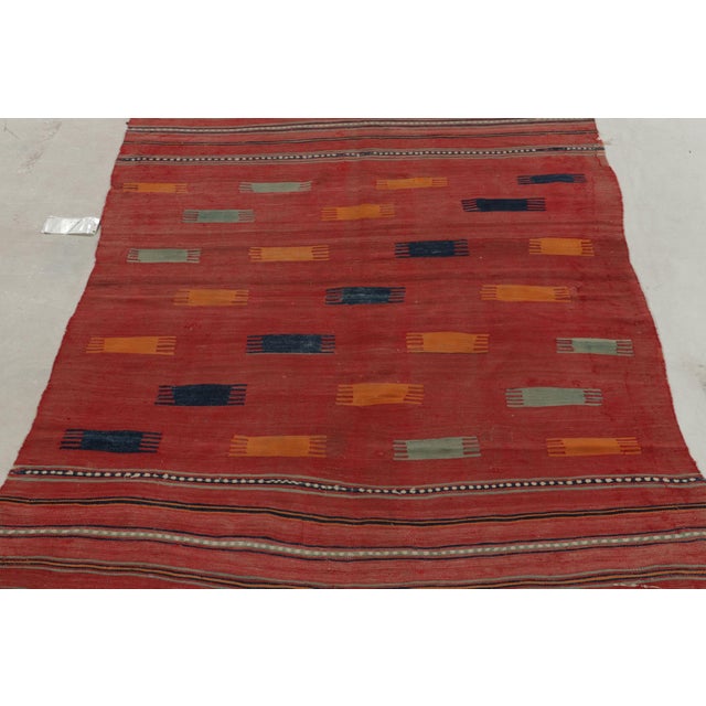 Connoting the celebrated tribal style, this 5x7 kilim rug hails from a special new curation of antique flat weaves. This...