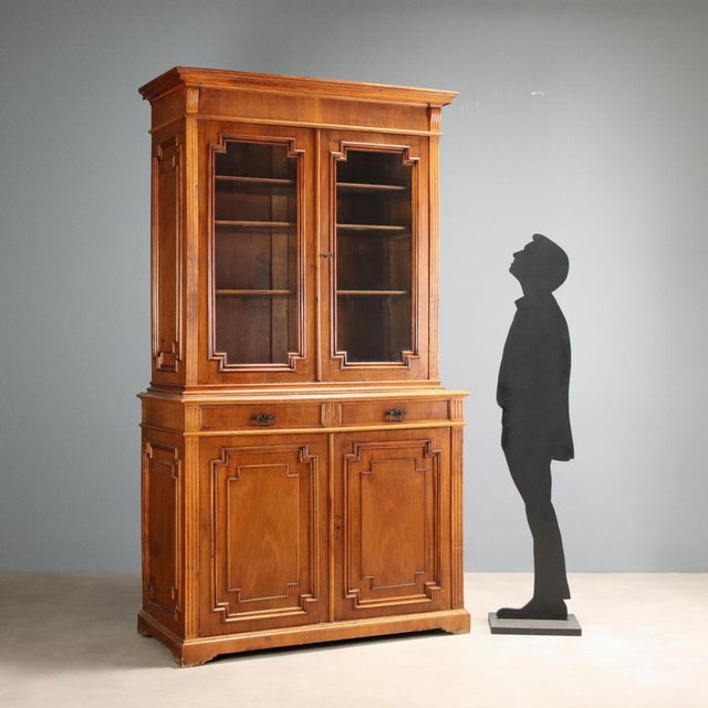 Late 19th-century walnut sideboard from Italy, featuring an elegant and functional design. The hutch has a pair of glass...