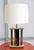 Single Italian Modernist table lamp. Brass frame with central enamelled metal column with brass leaf motif details.