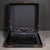 ABOUT An antique Remington Envoy typewriter in black crinkle finish with original leather case. The keys are white letters...