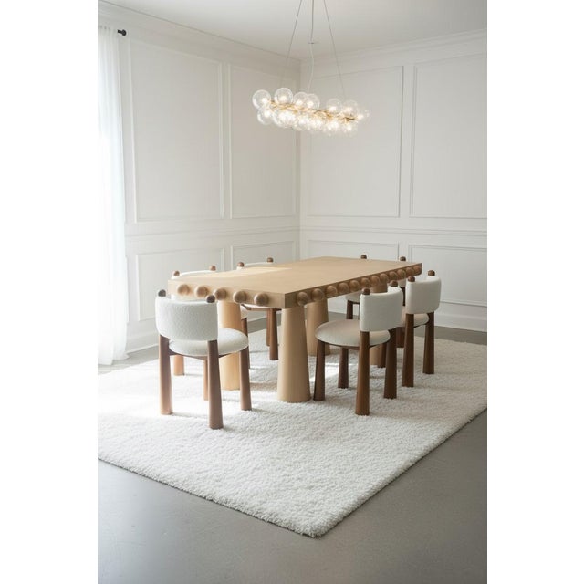 You will be getting 8 wood luxury dining chairs with white boucle upholstery Meet Talia—the dining chair that's equal...