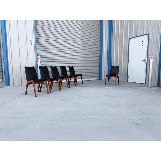 Featuring dramatic sweeping lines and sculpted organic frames, this set of six mid-century modern dining chairs brings a...