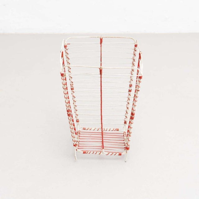 Metal paper bin made by wire woven in a classic cross-hatched pattern completed by a solid ring. Unknown manufacturer,...