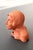 A small terracotta head made by hand and fired. Unique shape and folk art style. Long hair and expressive. Unsigned....