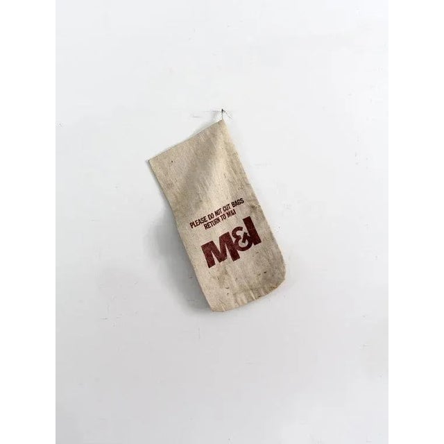 This is a vintage canvas money bag. The old bank bag features the company logo on the front and reads "Please Do Not Cut...