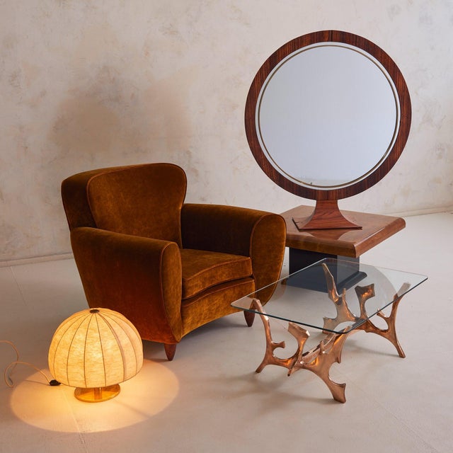 A 1970s Italian freestanding mirror, defined by its sculptural presence and exquisite materials. Its large circular frame...