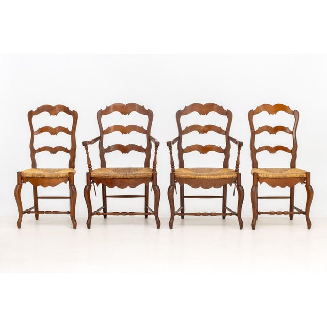 Set of Four French Provincial Style Walnut Dining Chairs, two armchairs and two side chairs, each with rush seat and...