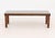 Modern Glass-Topped Walnut Coffee Table, the rectangular top above four cylindrical turned wood legs. 15.25" H x 45.75" W...