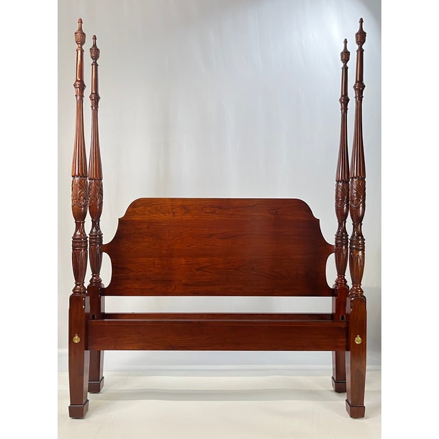 A wonderful Queen-size solid cherry four-poster bed attributed to the Colonial Furniture Company. This striking bench-made...