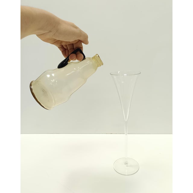 Made in Italy, 1910s. This pitcher vase is made in transparent pagliesco blown glass and the external surface is slightly...